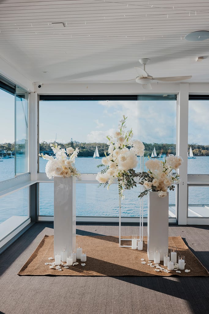 Noosa Boathouse view from River Room Wedding Reception Space with white wedding flowers on pillars