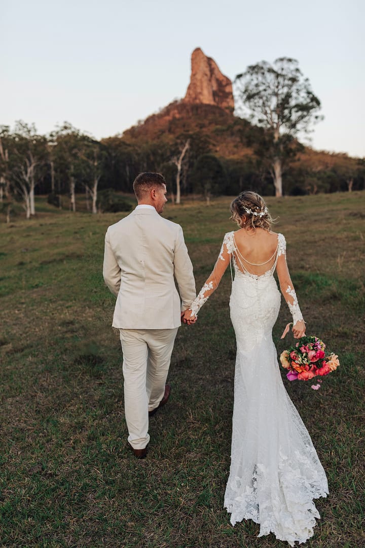 Bride and Groom walking towards Glasshouse Mountains